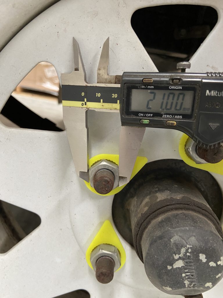 Measuring the wheel nut across flats using a vernier